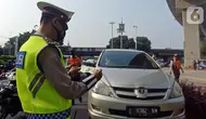 Polisi menghentikan mobil saat pemberlakuan ganjil genap di kawasan Fatmawati, Jakarta, Senin (25/10/2021). Pemberlakuan sistem ganjil genap di DKI Jakarta karena meningkatnya volume kendaraan di masa PPKM level 2. (Liputan6.com/Herman Zakharia)