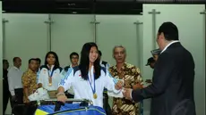 Usai berlaga di Asian Games 2014, tim bulutangkis Indonesia kembali ke tanah air dan tiba di Bandara Soekarno-Hatta pada Selasa, (30/9/2014). (Liputan6.com/Helmi Fithriansyah)