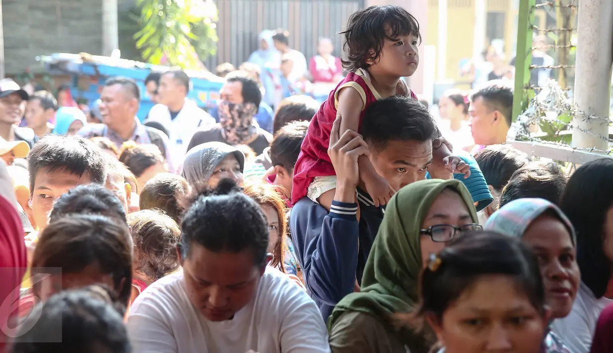 Sejumlah anak kecil iku mengantri saat kegiatan pasar murah di Jakarta, (12/6). Pasar murah yang diselenggarakan oleh Hati Suci tersebut bertujuan sebagai wadah untuk saling berbagi kepada sesama. (Liputan6.com/Faizal Fanani)