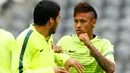 Penyerang Barcelona, Neymar berbincang dengan Luis Suarez saat menjalani sesi latihan di Allianz Arena, Munich, Jerman (11/5/2015).  Barcelona akan menantang Bayern Muenchen di leg kedua semifinal Liga Champions. (Reuters/Michaela Rehle)