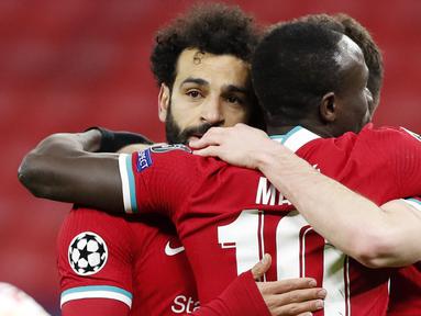 Para pemain Liverpool merayakan gol yang dicetak oleh Mohamed Salah ke gawang RB Leipzig pada laga Liga Champions di Puskas Arena, Kamis (11/3/2021). Liverpool menang dengan skor 2-0. (AP/Laszlo Balogh)
