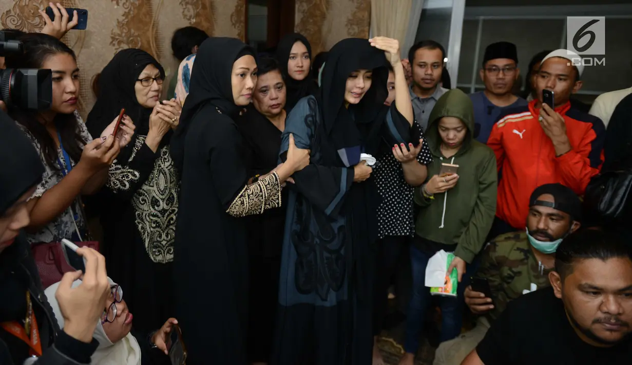 Istri gitaris grup band Seventeen Herman Sikumbang, Juliana Muhtar menangis saat menerima kedatangan jenazah suami di rumah duka di Pancoran, Jakarta Selatan, Senin (24/12). Uli tak henti meneteskan air mata. (Kapanlagi.com/Bayu Herdianto)