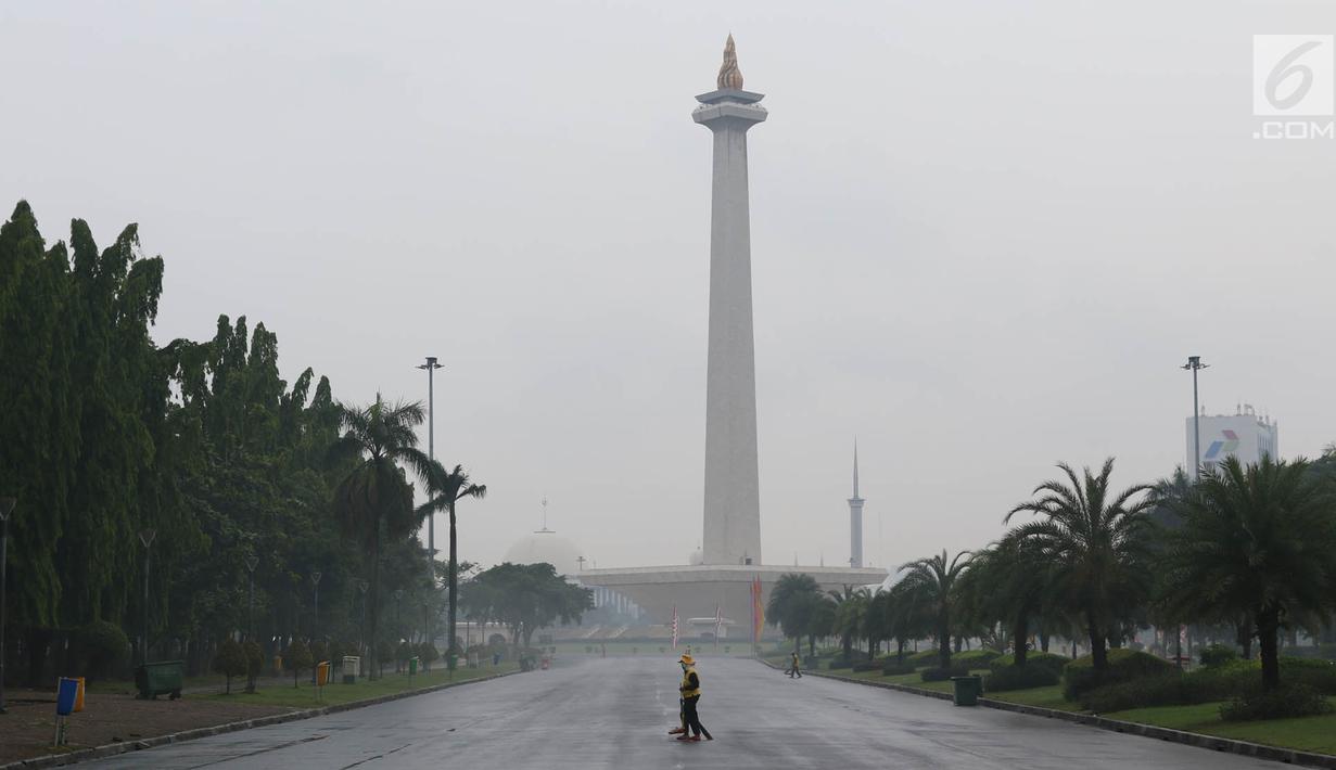 Petugas menyapu sampah yang tercecer di kawasan Monas, Jakarta, Senin (3/11). Kesigapan petugas kebersihan pasca reuni 212 membuat kawasan tersebut kembali bersih meskipun sehari sebelumnya dipenuhi ratusan ribu orang. (Liputan6.com/Immanuel Antonius)