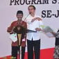 Jokowi menyerahkan sertifikat hak atas tanah program strategis nasional di Gedung New Sari Utama Convention Hall, Jember. (Biro