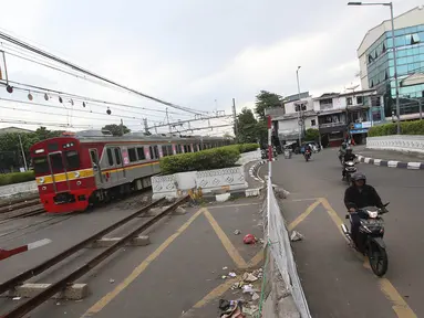 Rangkaian gerbong kereta melintas di perlintasan Jalan Angkasa Raya Kemayoran, Jakarta, yang ditutup, Kamis (26/10). Uji coba penutupan perlintasan kereta api itu sejak 13 Oktober  dan dijadwalkan hingga 27 Oktober 2017. (Liputan6.com/Immanuel Antonius)