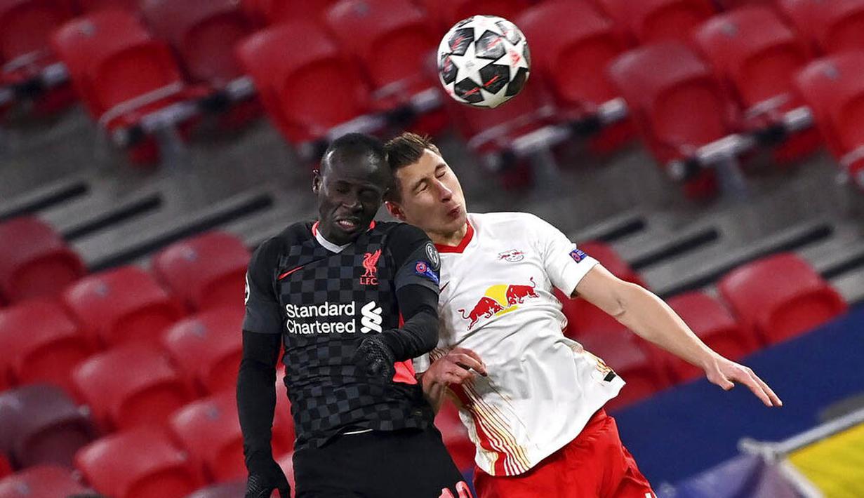 Striker Liverpool, Sadio Mane, duel udara dengan pemain RB Leipzig, Willi Orban, pada laga Liga Champions di Stadion Puskas, Rabu (17/2/2021). Liverpool menang dengan skor 2-0. (Tibor Illyes/MTI via AP)