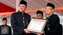 Gubernur DKI Jakarta Basuki Tjahaja Purnama menerima piagam penghargaan dari Bamus Betawi atas disahkannya perda tentang pelestarian kebudayaan Betawi, Jakarta, Minggu (23/8/2015). (Liputan6.com/Yoppy Renato)