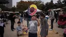  Seorang anak memainkan permainan tradisional selama perayaan Chuseok di Seoul (5/10). Seperti halnya kebanyakan festival panen lainnya di seluruh dunia, Chuseok dirayakan sekitar ekuinoks musim gugur. (AFP Photo/Ed Jones)