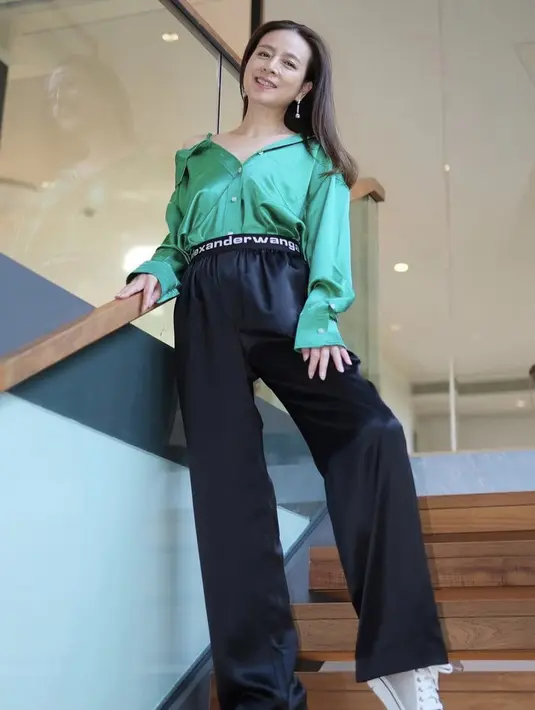 Madam Pang juga tampil chic dengan kemeja hijau dipadukan dengan loose pants hitam dari Alexander Wang. Cantik dengan aksesori anting menjuntai. @panhlamaam.