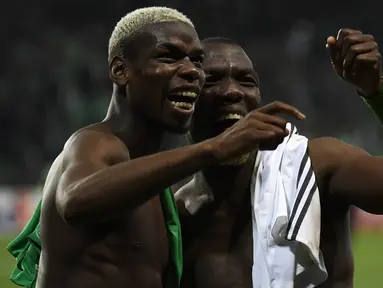 Gelandang Manchester United Paul Pogba (kiri) dan bek Saint-Etienne Florentin Pogba bertemu pada Liga Europa, di Stade Geoffroy-Guichard, Rabu (22/2). Pogba bersaudara saling bertukar jersey usai MU menang 1-0 atas Saint-Etienne. (PHILIPPE DESMAZES/AFP)