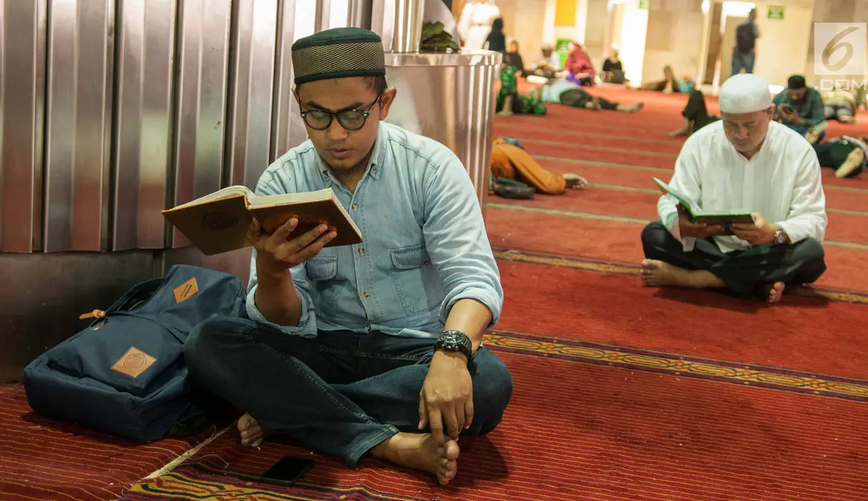 Jamaah membaca kitab suci Al Quran seusai salat Jumat di Masjid Istiqlal, Jakarta, Jumat (2/6). Waktu luang diisi warga dengan membaca Al-quran atau beristirahat di masjid sambil menunggu waktu berbuka puasa. (Liputan6.com/Gempur M Surya)
