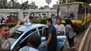 Pendemo melakukan sweeping terhadap taksi yang sedang melintasi jalan Gatot Subroto  saat demo di depan Gedung DPR/MPR, Jakarta, Selasa (22/3). Mereka menuntut pemerintah untuk membekukan jasa transportasi berbasis online. (Liputan6.com/Johan Tallo)