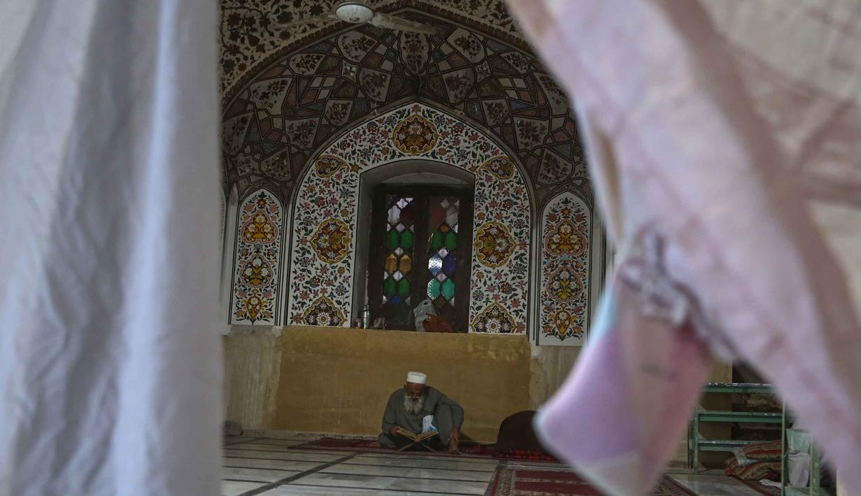 Itikaf sangat dianjurkan, terutama pada 10 hari terakhir bulan Ramadan untuk meraih Lailatul Qadar. Tampak dalam foto, seorang jamaah Muslim membaca Al Quran saat mereka melaksanakan Itikaf, selama sepuluh hari terakhir bulan Ramadan, di salah satu masjid, di Peshawar, Pakistan, Selasa 10 Maret 2026. (AP Photo/Muhammad Sajjad)
