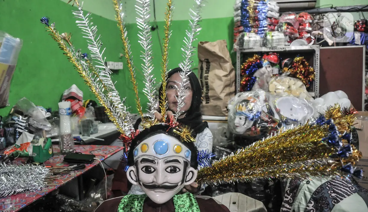 Pengrajin menyelesaikan produksi miniatur ondel-ondel di industri rumahan kesenian Betawi Raja Ondel-Ondel, Jakarta, Senin (13/12/2021). Penyaluran KUR kepada UMKM hingga November 2021 setara 92,26 persen dari target total penyaluran KUR sebesar Rp 285 triliun. (merdeka.com/Iqbal S. Nugroho)