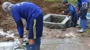 Petugas menyelesaikan pembuatan sumur resapan di kawasan Monas, Jakarta, Selasa (26/2). Pemkot Jakarta Pusat akan membangun 1.000 sumur resapan yang tersebar di berbagai lokasi untuk menampung air hujan. (Liputan6.com/Immanuel Antonius)