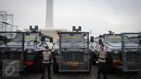 Anggota polisi berdiri didekat deretan kendaraan taktis (rantis) jelang apel gelar pasukan ops Mantap Praja Jaya dalam rangka PAM Pilkada Serentak Tahun 2017 di Lapangan Monas, Jakarta, Rabu (12/10). (Liputan6.com/Faizal Fanani)