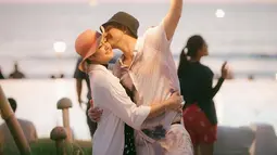 Rifky Balweel dengan romantis mengecup pipi sang istri di bawah langit senja. (Foto: Instagram/ bibyalraen13)