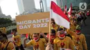 Ratusan buruh migrant menggelar kirab dikawasan Bundaran Hi, Jakarta, Minggu 18/12/2022). Kegiatan kirab tersebut untuk memperingati puncak hari migrant 2022. (Liputan6.com/Faizal Fanani)