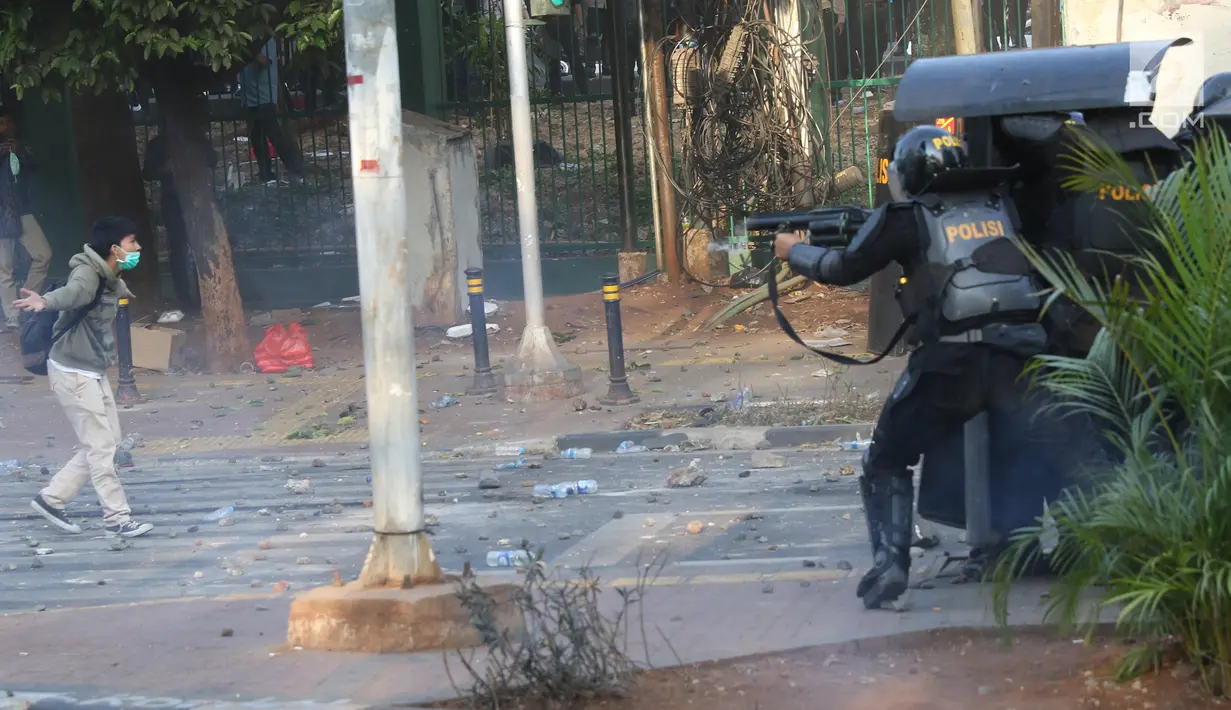 Seorang peserta aksi berusaha mendekati barisan polisi dalam unjuk rasa di sekitaran Gedung DPR RI, Jakarta, Senin (30/9/2019). Kericuhan pecah lantaran massa yang kebayakan terdiri dari pelajar tersebut berusaha masuk ke area depan DPR. (Liputan6.com/Angga Yuniar)
