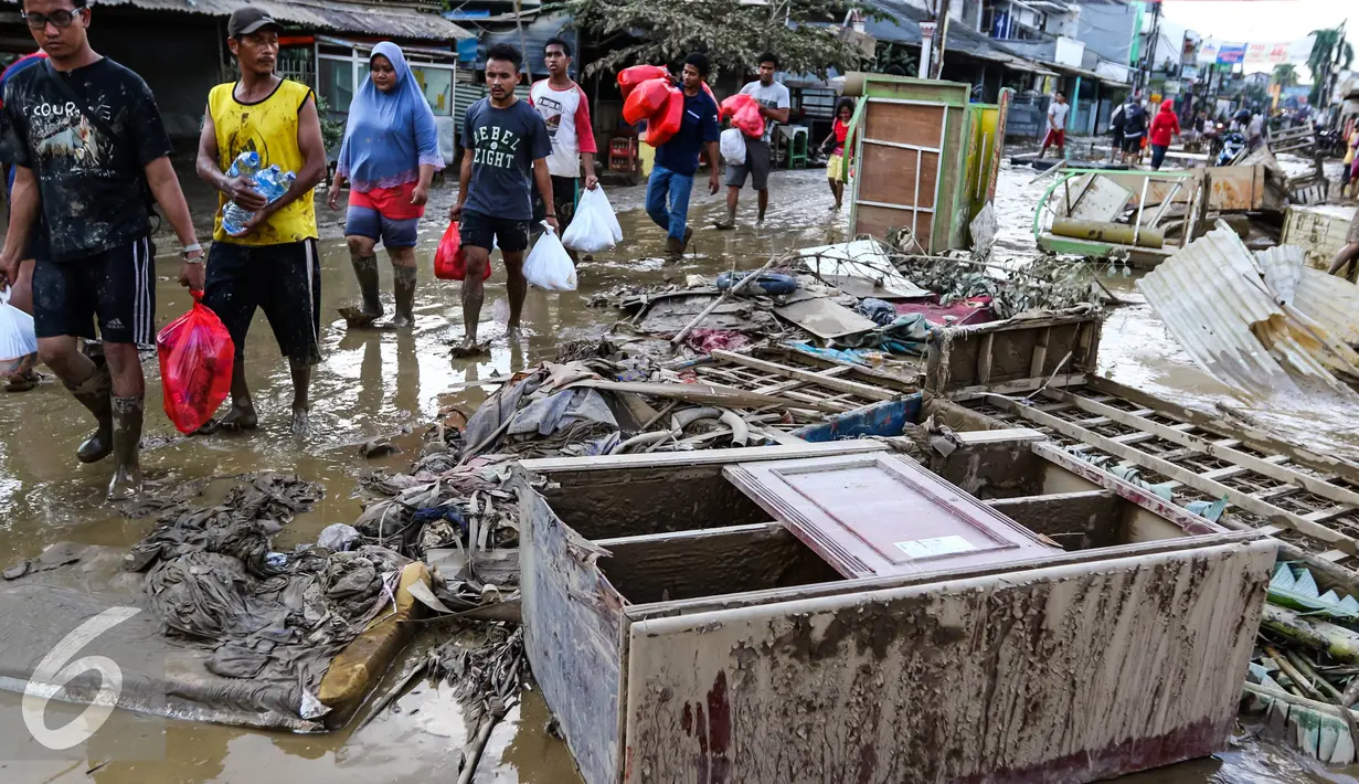 Sebuah lemari dan perabotan rumah tangga menumpuk di pinggir jalan usai banjir menggenangi komplek Pondok Gede Permai Jatiasih, Bekasi, Jumat (22/04). (Liputan6.com/Fery Pradolo)