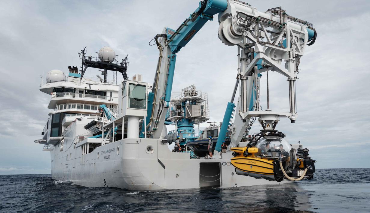 Keduanya adalah Nadir yang difokuskan untuk mendukung aspek media dan dokumentasi visual, lalu Neptune yang lebih diarahkan untuk saintifik. Tampak dalam foto yang diambil pada 12 Januari 2026, menunjukkan sebuah kapal selam yang diturunkan oleh derek dari OceanXplorer, sebuah kapal penelitian yang dioperasikan oleh organisasi nirlaba kelautan OceanX, untuk misi laut dalam di perairan lepas pantai pulau Sulawesi. (YASUYOSHI CHIBA/AFP)