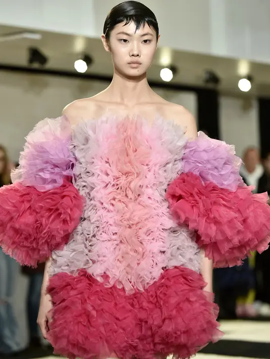 Seorang model berjalan di runway mengenakan koleksi busana rancangan desainer Jepang, Tomo Koizumi  pada New York Fashion Week di Marc Jacobs Madison, 8 Februari 2019. Koizumi menampilkan parade gaun awan berwarna pelangi (Steven Ferdman/Getty Images/AFP)