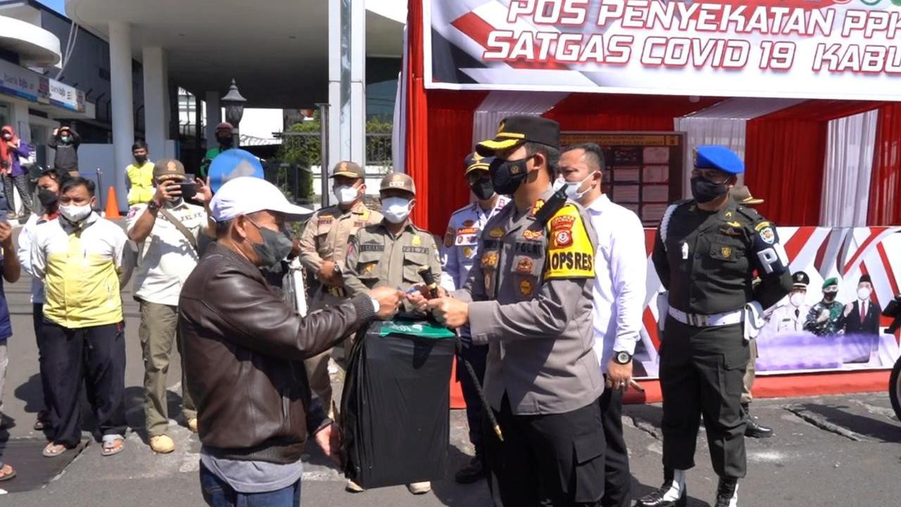 Kapolres Garut AKBP Wirdhanto Hadicaksono sekaligus Wakil Ketua Satgas Covid-19 Garut tengah memberikan paketan nasi kotak bagi perwakilan PKL Pengkolan Garut, Jawa Barat.