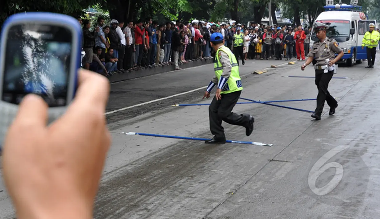 Suasana oleh TKP kecelakaan maut Outlander yang menewaskan 4 orang di Arteri Pondok Indah. Tampak seorang warga mengabadikan peristiwa tersebut dengan kamera ponselnya, Jakarta, Kamis (22/1/2015). (Liputan6.com/Miftahul Hayat)