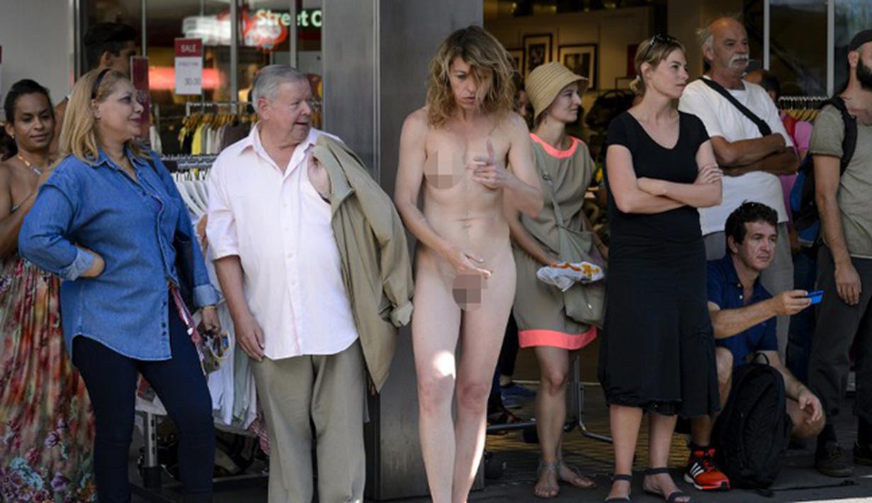  Seorang wanita tanpa busana tampak berdiri di tempat umum saat menggelar aksi teatrikal dalam Festival “Body and Freedom” di Kota Biel, Swiss, Jumat (21/8/2015). Festival ini berlangsung dari 21-22 Agustus. (AFP PHOTO/Fabrice Coffrini)