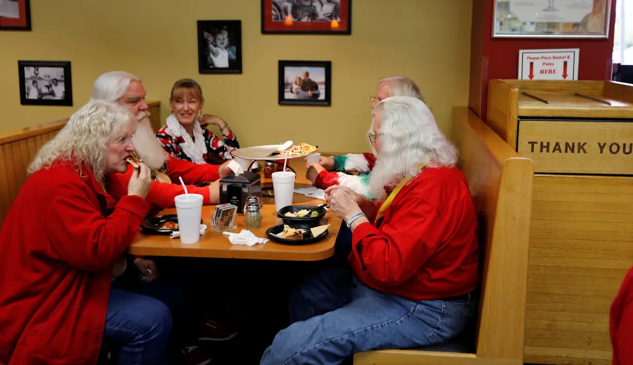 Calon Santa Claus makan siang disela waktu istirahat dari kelas Charles W. Howard Santa Claus School di Midland, Michigan, 27 Oktober 2016. Sekolah ini untuk belajar menjadi seorang Santa Claus yang baik dan menyakinkan. (REUTERS/Christinne Muschi)