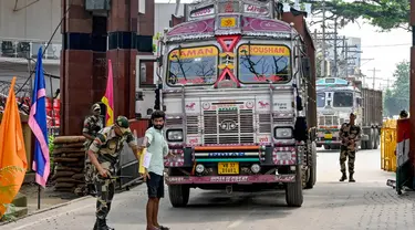 Personel Pasukan Keamanan Perbatasan (BSF) memeriksa seorang pengemudi truk ketika ia kembali ke India setelah mengantarkan pasokan ke Bangladesh, di perbatasan India-Bangladesh, Petrapole, sekitar 100 km sebelah timur laut Kolkata pada tanggal 6 Agustus 2024. (Dibyangshu SARKAR/AFP)