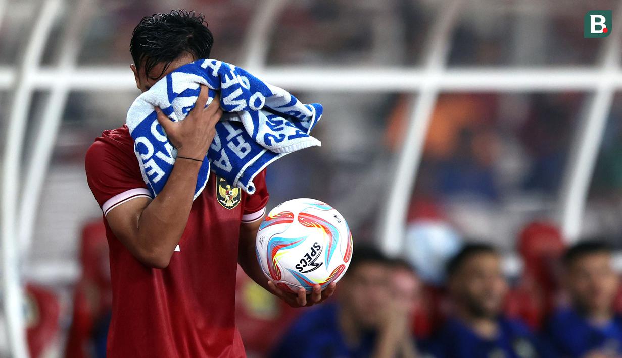 Pemain Timnas Indonesia, Pratama Arhan menyeka mukanya menggunakan handuk sebelum melakukan lemparan ke dalam pada laga FIFA Matchday melawan Argentina yang berlangsung di Stadion Utama Gelora Bung Karno (SUGBK), Senayan, Jakarta, Senin (19/06/2023). (Bola.com/Bagaskara Lazuardi)