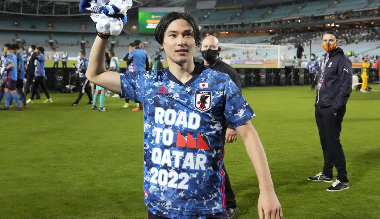 Penyerang Jepang, Takumi Minamino melempar handuk ke penonton saat berselebrasi usai pertandingan play-off Piala Dunia 2022 melawan Australia di Stadium Australia di Sydney, Kamis (24/3/2022). Kemenangan ini juga memastikan Jepang mengamankan satu tiket Piala Dunia 2022. (AP Photo/Mark Baker)