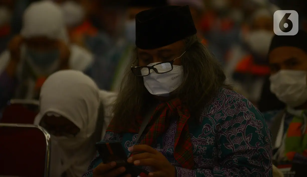 Jemaah calon haji kelompok terbang (kloter) 1 embarkasi haji Jakarta - Pondok Gede menunggu keberangkatan menuju Bandara Soekarno - Hatta di Asrama Haji Pondok Gede, Jakarta, Sabtu (4/6/2022) dini hari. Sebanyak 389 calon haji asal DKI Jakarta yang tergabung dalam kloter 1 embarkasi haji Jakarta - Pondok Gede diberangkatkan menuju tanah suci Arab Saudi melalui Bandara Internasional Soekarno - Hatta. (merdeka.com/Imam Buhori)