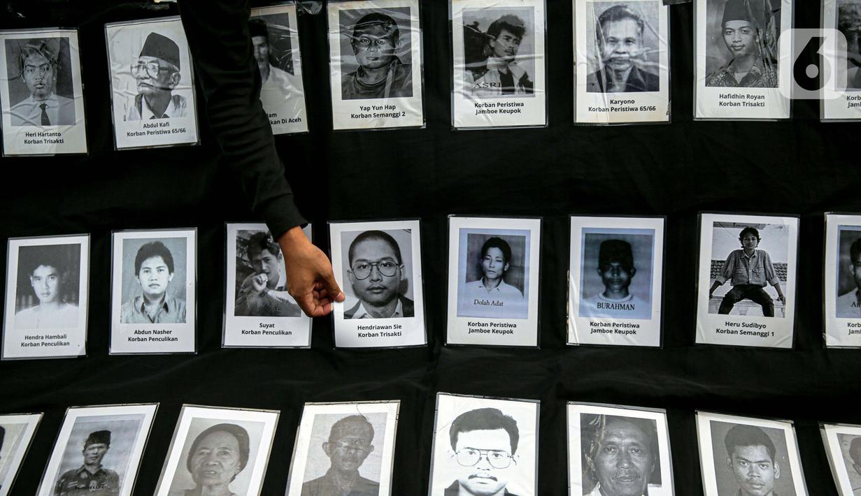 Foto para korban pelanggaran HAM ditampilkan saat anggota Jaringan Solidaritas Korban untuk Keadilan (JSKK) melakukan Aksi Kamisan ke-795 di seberang Istana Merdeka, Jakarta, Kamis (16/11/2023). (Liputan6.com/Faizal Fanani)