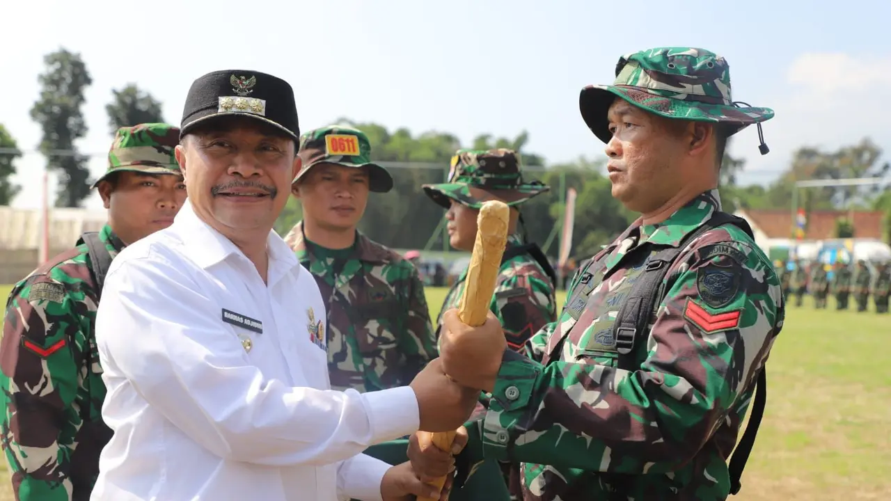 Pemberian simbolis cangkul kepada perwakilan prajurit TNI dalam apel pembukaan program TMMD Reguler Kodim 0611/Garut Ke 120 Tahun Anggaran 2024 di Desa Cintadamai, Kec. Sukaresmi, Kab. Garut, Jawa Barat. (Liputan6.com/Jayadi Supriadin)