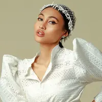 Novia Bachmid kerap mendapatkan julukan sebagai 'Beyonce Indonesia'. Pasalnya, selain memiliki suara yang merdu, ia juga memiliki penampilan memesona dengan kulitnya yang cokelat eksotis. Apalagi saat mengenakan busana putih, Novia tampil makin menawan.(Liputan6.com/IG/@noviabachmid)