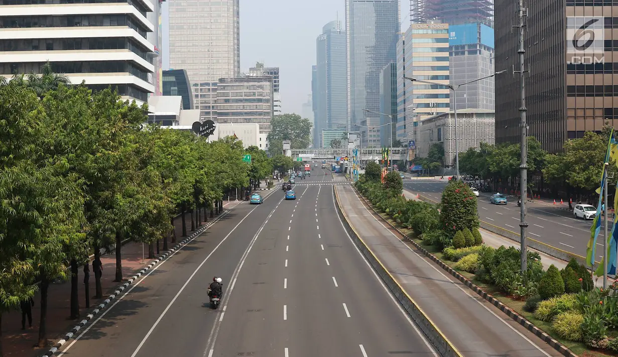 Sejumlah kendaraan melewati jalan yang lengang di Jalan MH Thamrin, Jakarta, Kamis (27/6/2019). Adanya rekayasa lalu lintas di sejumlah titik terkait sidang putusan Mahkamah Konstitusi menyebabkan jalan protokol di pusat kota itu lebih lengang dibanding hari biasa. (Liputan6.com/Immanuel Antonius)