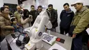 Sebuah robot dari Shenzhen Akademi Robotika membuat sketsa wajah saat pameran robot di Konferensi Robot Dunia, Beijing, Cina,  (24/11). Konferensi robot ini diadakan selama tiga hari dari senin lalu. (REUTERS/Jason Lee)