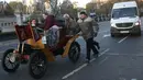 Peserta mendorong mobil antik mereka yang mogok saat mengikuti kegiatan tur tahunan dengan mobil veteran dari London ke Brighton di London, Inggris (6/11). Mobil-mobil tersebut ada yang usianya sudah lebih dari 100 tahun. (Reuters/Neil Balai)