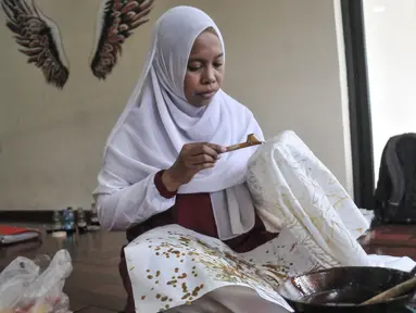 Warga menyelesaikan pembuatan batik saat pelatihan Batik Tulis Koja di Tempat Kumpul Kreatif (TKK) Pasar Permai, Jakarta Utara, Senin (3/10/2022). Pelatihan yang digelar komunitas Batik Tulis Koja tersebut diperuntukkan bagi masyarakat umum, terutama warga Jakarta Utara sebagai bentuk meningkatkan minat serta melestarikan budaya batik yang mulai tergerus zaman. (merdeka.com/Iqbal S. Nugroho)