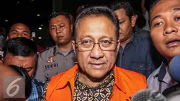 Ketua DPD RI Irman Gusman keluar dari gedung KPK Jakarta menuju ke mobil tahanan KPK usai diperiksa, Sabtu (17/9). Irman Gusman ditahan KPK setelah terkena OTT terkait dugaan suap kebijakan kuota gula impor. (Liputan6.com/Faizal Fanani)