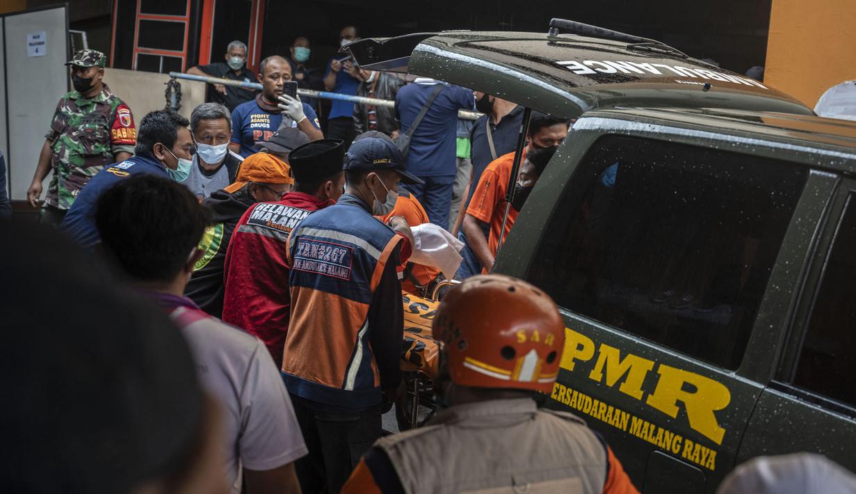 Petugas medis menerima jenazah di sebuah rumah sakit di Malang, Jawa Timur pada 2 Oktober 2022. Sedikitnya 174 orang tewas di stadion sepak bola Indonesia ketika ribuan penggemar tuan rumah yang marah menyerbu lapangan dan polisi menanggapi dengan gas air mata yang memicu desak-desakan, kata pihak berwenang pada 2 Oktober. (AFP/Juni Kriswanto)