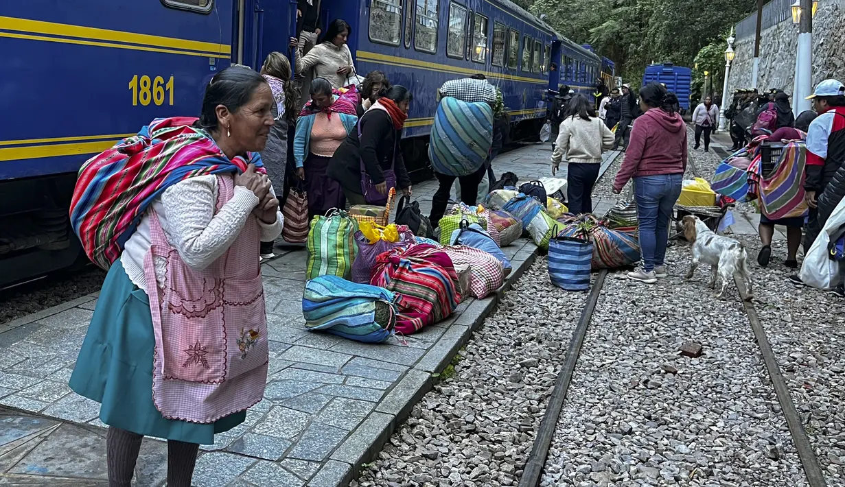 Penduduk dan pengunjung tiba di Machu Picchu, Peru dengan kereta pertama setelah layanan dari Ollantaytambo diperbarui, Rabu (8/2/2023). Layanan kereta api ke Machu Picchu di Peru sebagian diaktifkan kembali Rabu ini untuk mengangkut penduduk lokal, setelah penangguhan hampir tiga minggu karena blokade rel kereta api akibat protes anti-pemerintah yang mengguncang negara Andes. (Carolina Paucar / AFP)