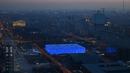 National Aquatics Center yang dikenal sebagai Ice Cube venue untuk curling pada Olimpiade Musim Dingin 2022 terlihat di Beijing, 3 Januari 2022. Olimpiade Musim Dingin 2022 akan dibuka pada 4 Februari mendatang. (GREG BAKER/AFP)