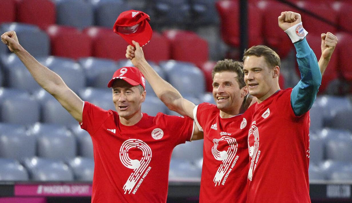 Pemain Bayern Munchen, Robert Lewandowski, Thomas Mueller dan Manuel Neuer merayakan gelar juara usai menaklukkan Moenchengladbach pada laga Liga Jerman di Allianz Arena, Sabtu (8/5/2021). Bayern Munchen menang enam gol tanpa balas. (Peter Kneffel/Pool via AP)