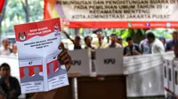 Petugas KPPS memperlihatkan contoh surat suara kepada pemilih saat simulasi pemungutan dan pencoblosan surat suara Pemilu 2019 di Taman Suropati, Jakarta, Rabu (10/4). Simulasi itu untuk meminimalisir kesalahan dan kekurangan saat pencoblosan pemilu pada 17 April nanti. (Liputan6.com/Johan Tallo)
