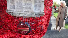 Ratu Inggris, Camilla, memasang bunga poppy terakhir untuk melengkapi rangkaian 10.000 bunga poppy yang menghiasi menara gereja di Gereja St. Bartholomew di Corsham, Inggris, pada Selasa 28 Oktober 2025. Kunjungan ini menjadi bagian dari kunjungan Ratu Inggris, Camilla, ke The Poppy Project. (Chris Jackson/POOL/AFP)