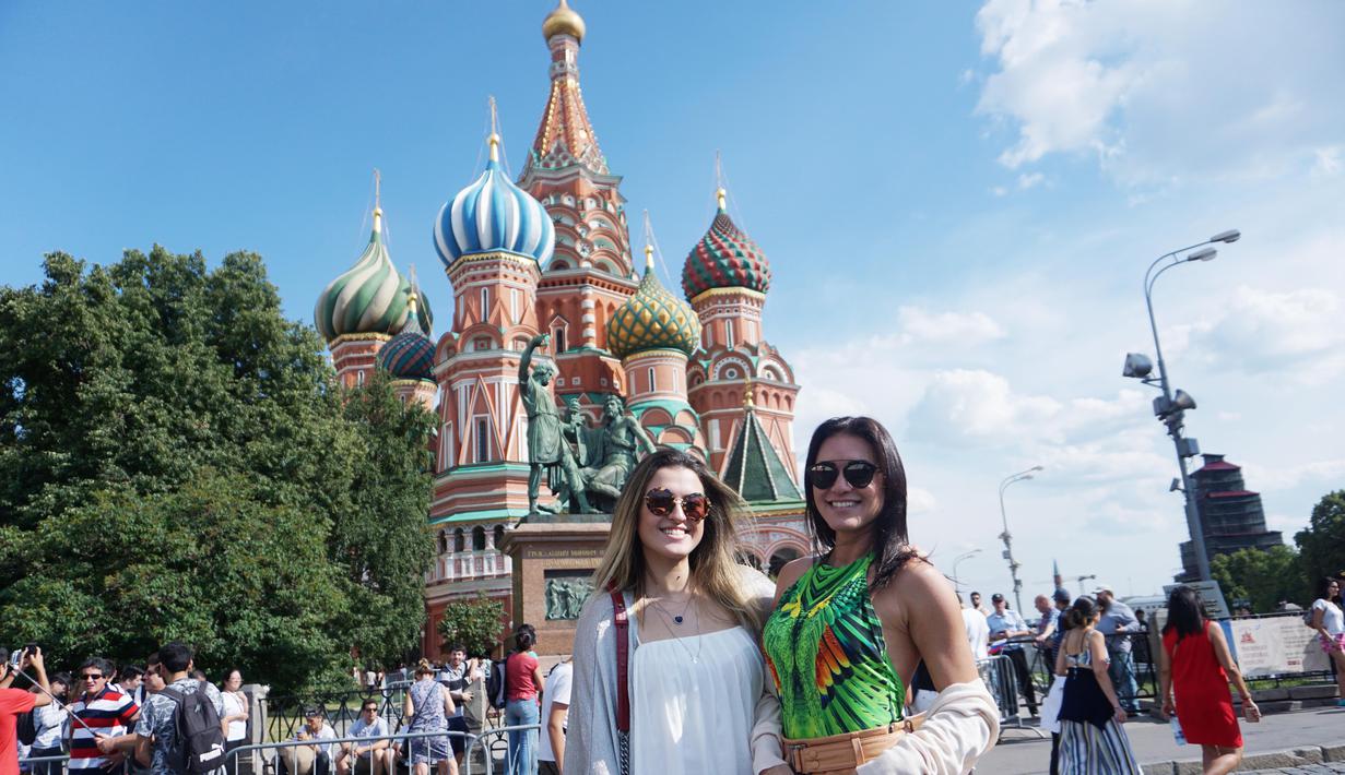 Dua wanita cantik asal Brasil, Amanda dan Patricia berpose di depan Saint Basil's Cathedral, Moskow, Rusia. (Bola.com/Okie Prabhowo)