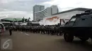 Personel kepolisian berjalan usai apel sore usai menjalankan tugas pengamanan gedung DPR RI, Jakarta, Kamis (30/3). Pengamanan terkait isu aksi massa pada 30 dan 31 Maret 2017. (Liputan6.com/Helmi Fithriansyah)